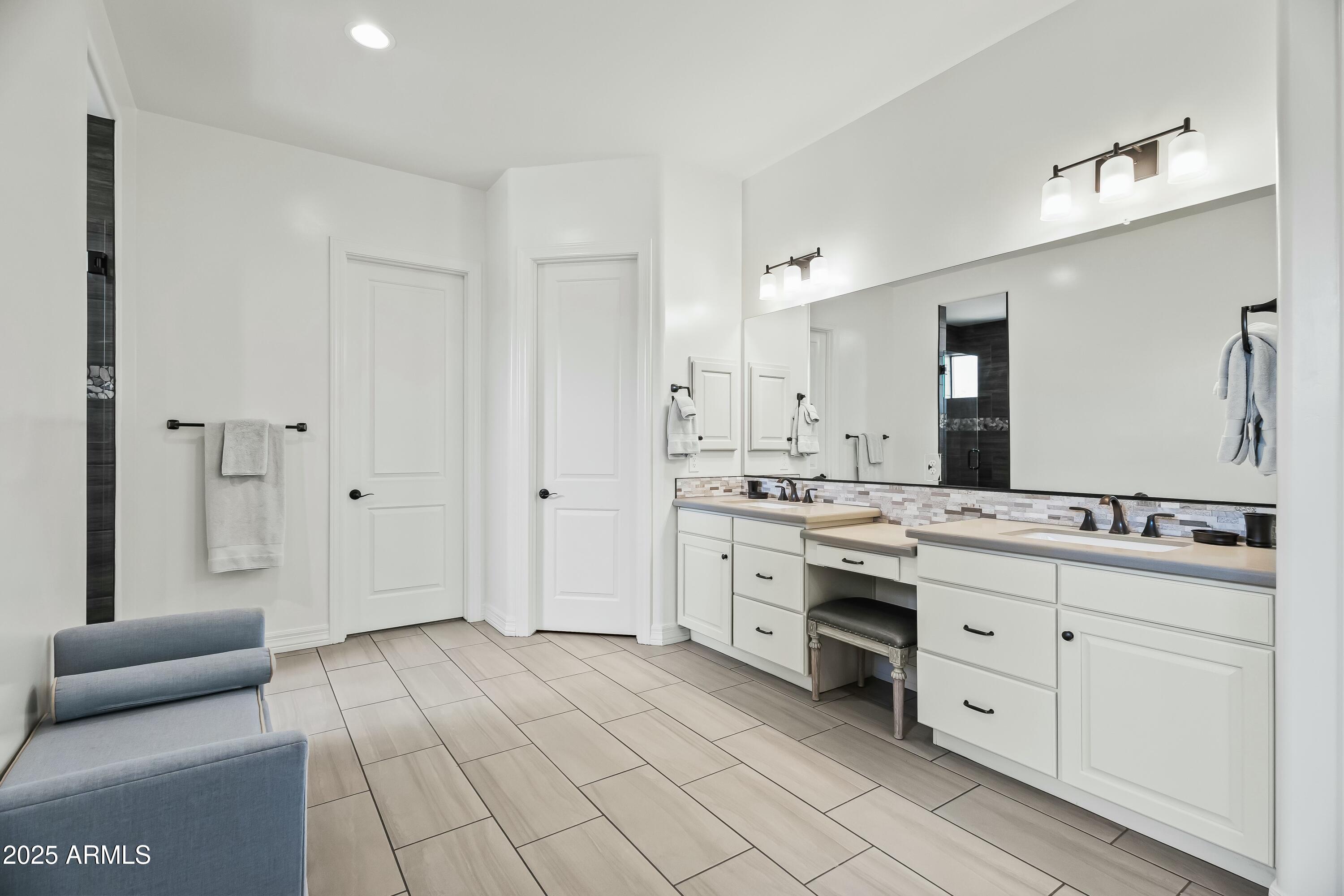 8769 East Granite Pass Road Scottsdale, AZ 85266 - Photo 10 of 23 a spacious bathroom with a double vanity sink a mirror and a