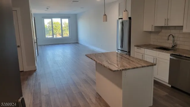 a kitchen with granite countertop a sink and a stove top oven