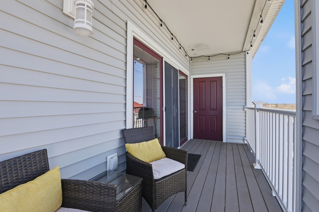 233 Beach Road, Unit A10 Salisbury, MA 01952 - Photo 11 of 39 a view of a deck with wooden floor and furniture