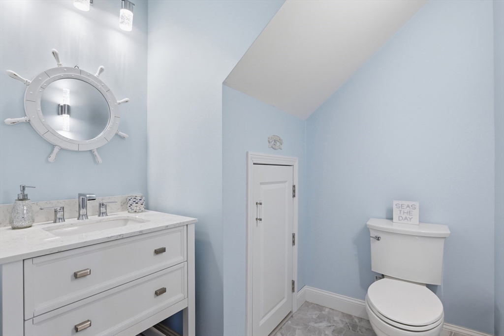 233 Beach Road, Unit A10 Salisbury, MA 01952 - Photo 14 of 39 a bathroom with a toilet a sink and mirror