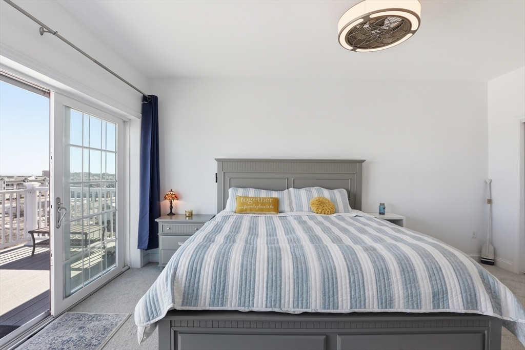233 Beach Road, Unit A10 Salisbury, MA 01952 - Photo 17 of 39 a bed sitting in a bedroom next to a window