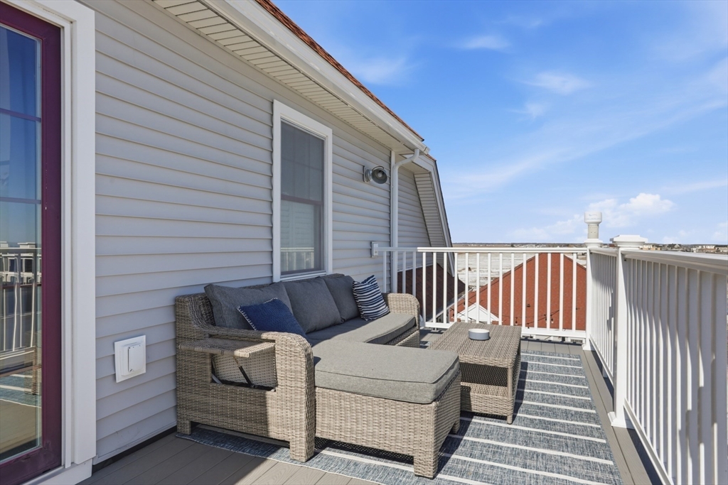 233 Beach Road, Unit A10 Salisbury, MA 01952 - Photo 21 of 39 a roof deck with couches and wooden floor