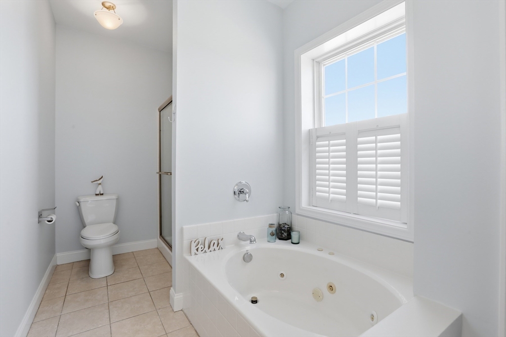 233 Beach Road, Unit A10 Salisbury, MA 01952 - Photo 25 of 39 a bathroom with a bathtub and a toilet