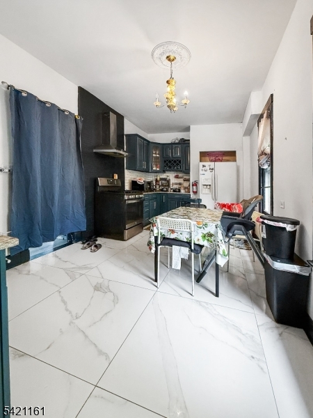 66 Washington Place East Rutherford, NJ 07073 - Photo 2 of 35 a living room with furniture a chandelier and a flat screen tv