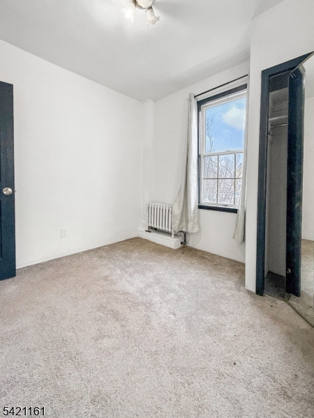 66 Washington Place East Rutherford, NJ 07073 - Photo 26 of 35 an empty room with a fireplace and windows