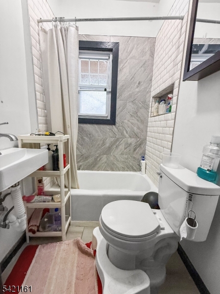 66 Washington Place East Rutherford, NJ 07073 - Photo 34 of 35 a white toilet sitting next to a bathroom sink and tub