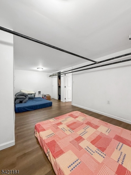 66 Washington Place East Rutherford, NJ 07073 - Photo 8 of 35 a spacious bedroom with a bed and a lamp on the table