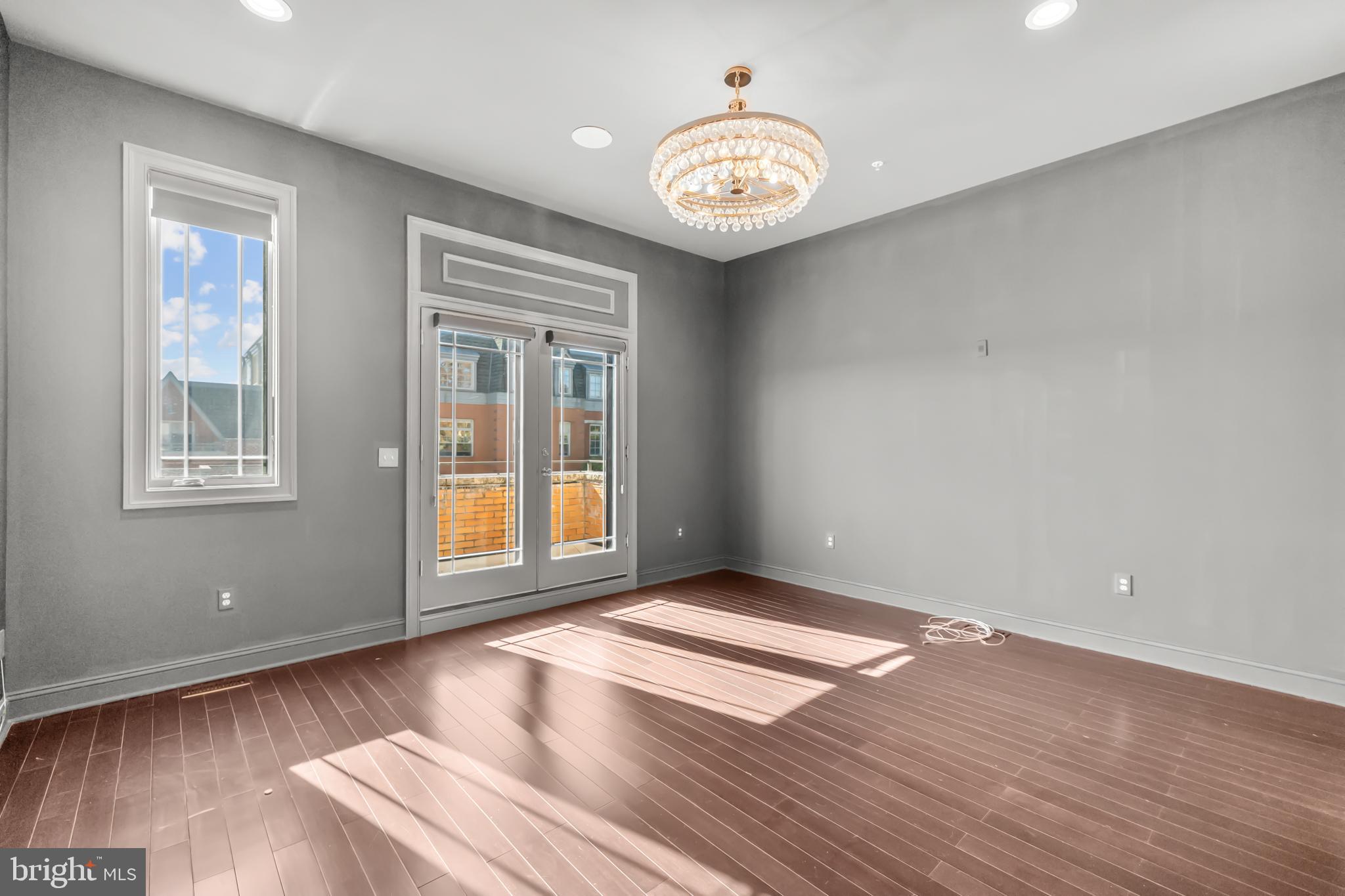 151 V Street Northwest, Unit 4 Washington, DC 20001 - Photo 28 of 49 a view of an empty room with wooden floor and a window