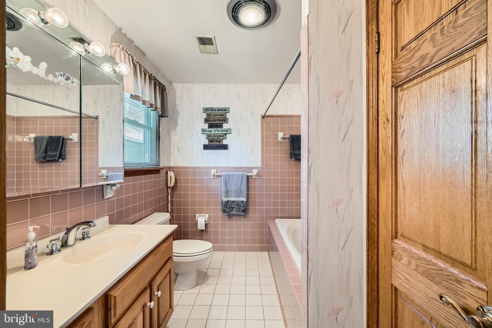 1722 Anne Avenue Baltimore, MD 21221 - Photo 15 of 28 a bathroom with a toilet sink and mirror