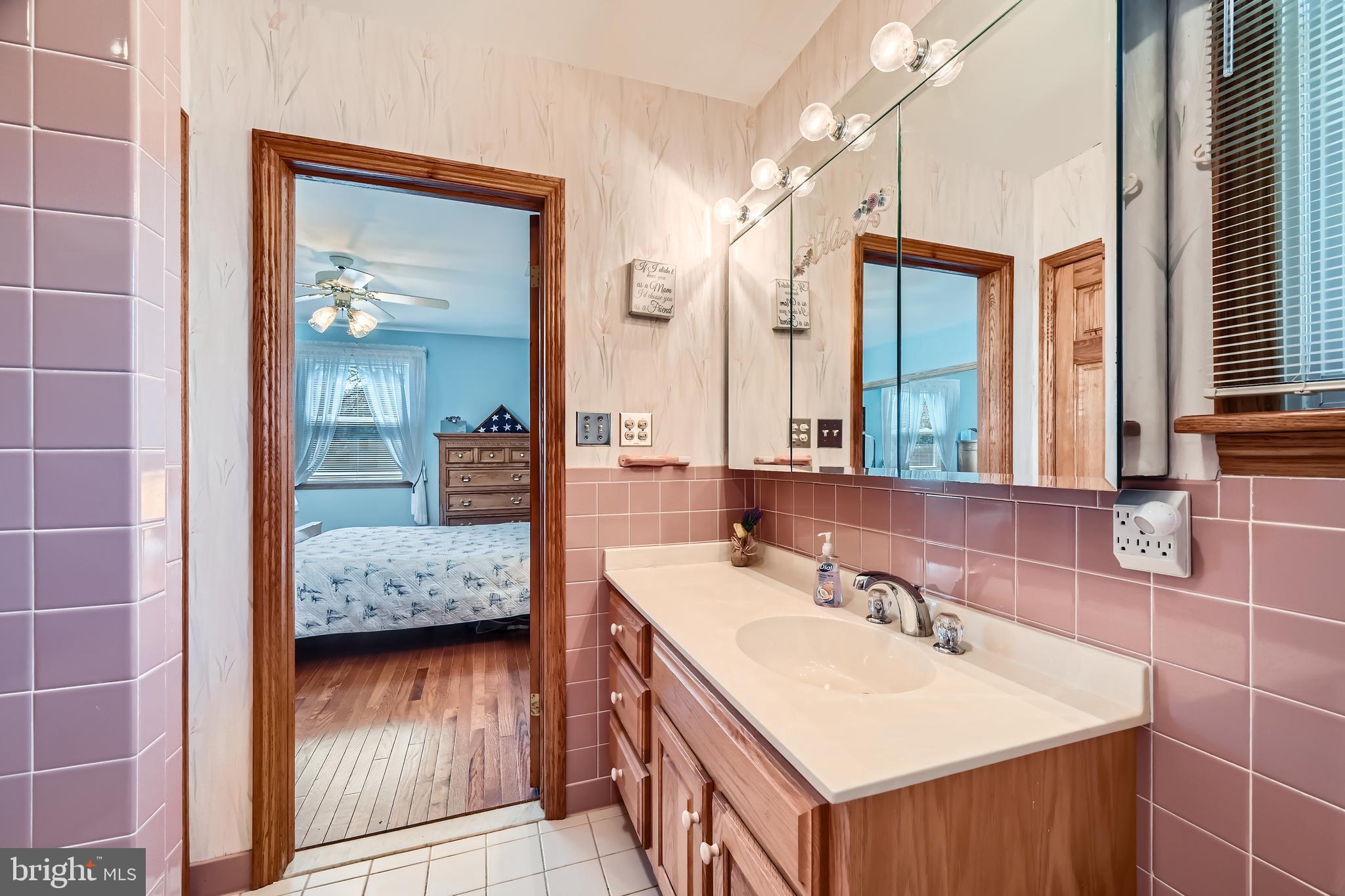 1722 Anne Avenue Baltimore, MD 21221 - Photo 17 of 28 a en suite bathroom with a sink double vanity and mirror
