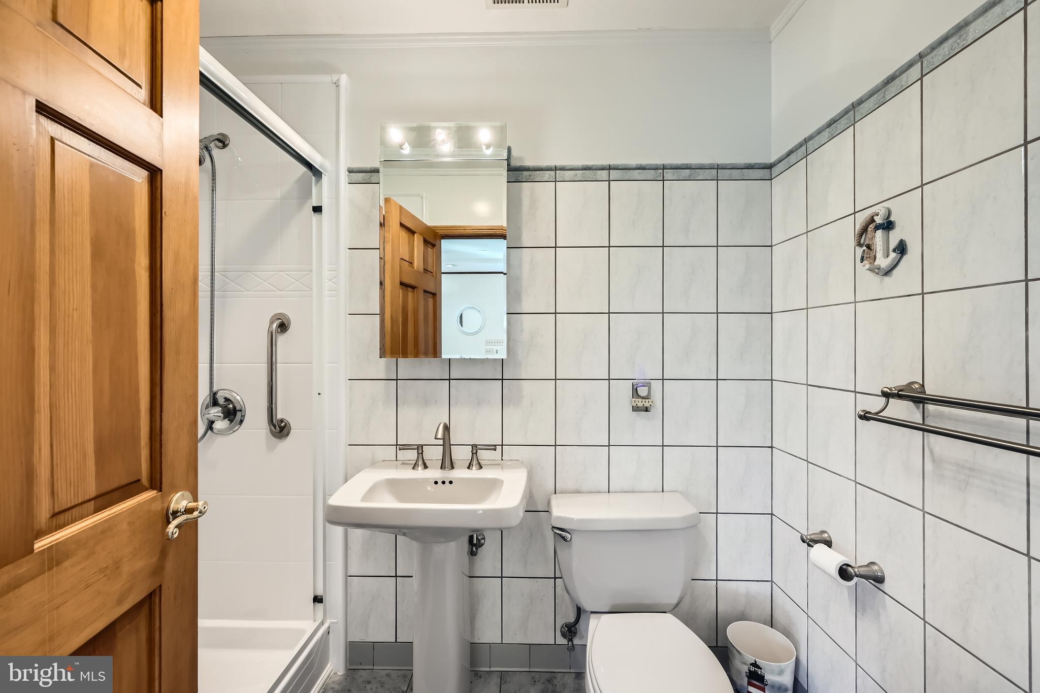 1722 Anne Avenue Baltimore, MD 21221 - Photo 19 of 28 a bathroom with a sink toilet and shower