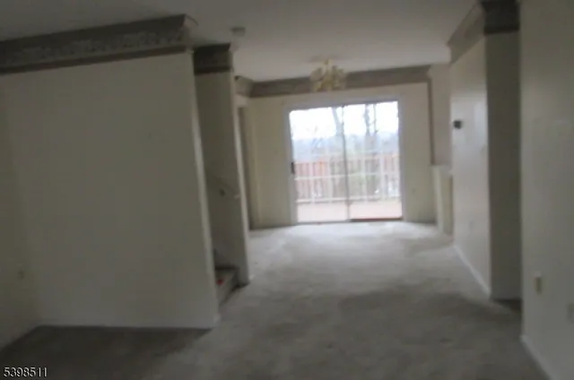 a view of empty room with floor to ceiling window