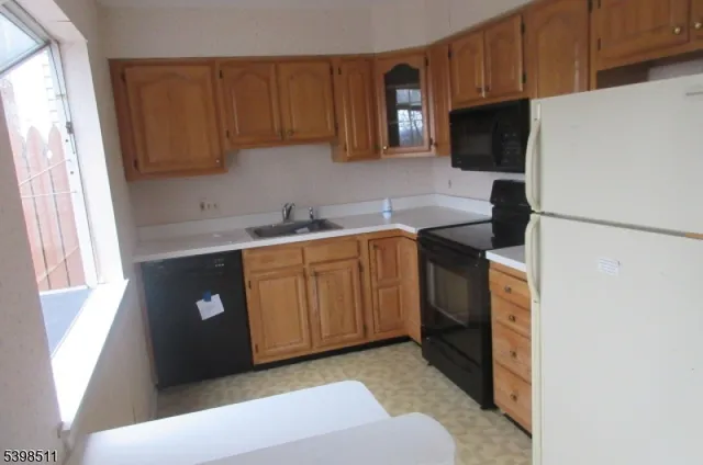 a kitchen with a sink a stove and cabinets