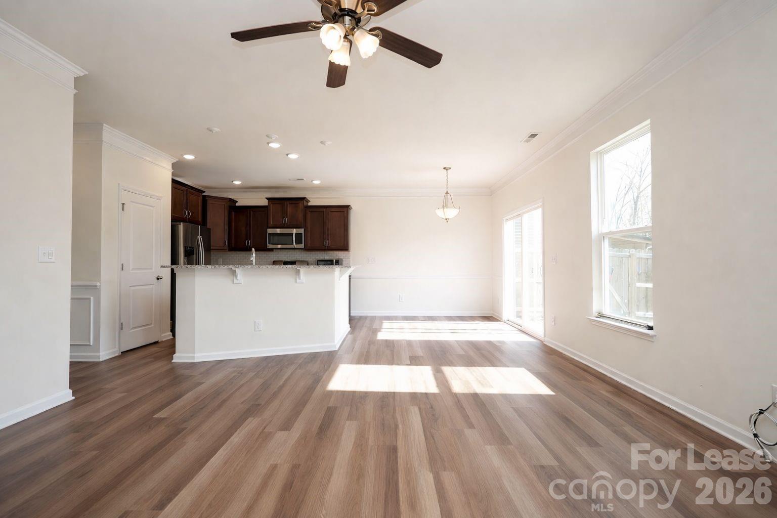 3220 Berry Creek Road Charlotte, NC 28214 - Photo 12 of 41 a view of open kitchen with wooden floor and electronic appliances
