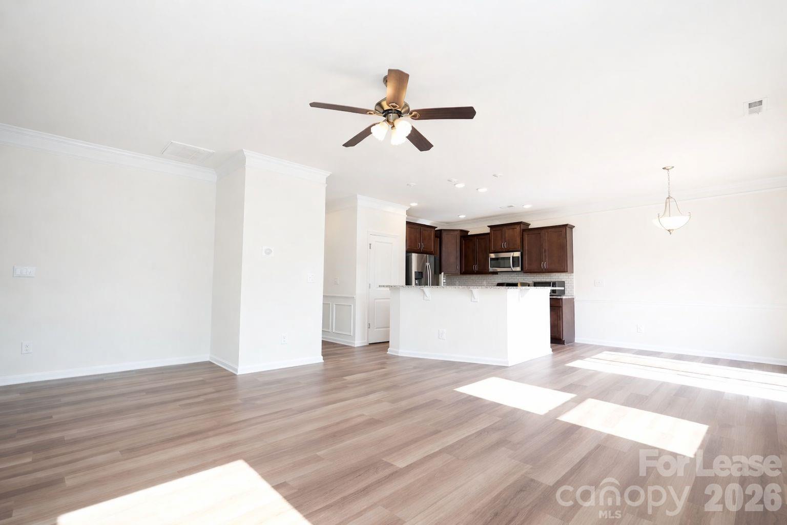 3220 Berry Creek Road Charlotte, NC 28214 - Photo 13 of 41 a view of a living room with kitchen and wooden floor