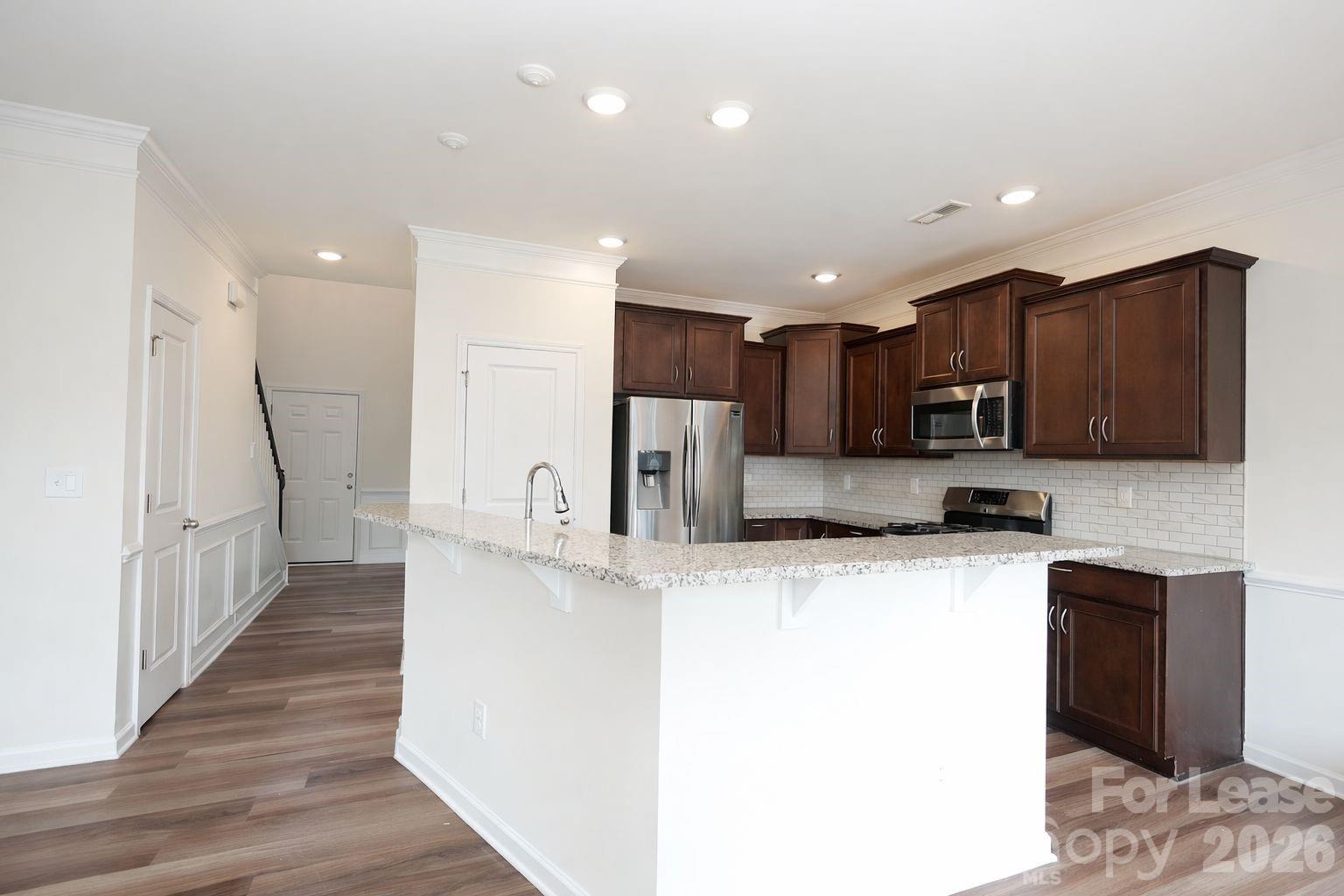 3220 Berry Creek Road Charlotte, NC 28214 - Photo 17 of 41 a kitchen with stainless steel appliances granite countertop a refrigerator a sink a stove and oven