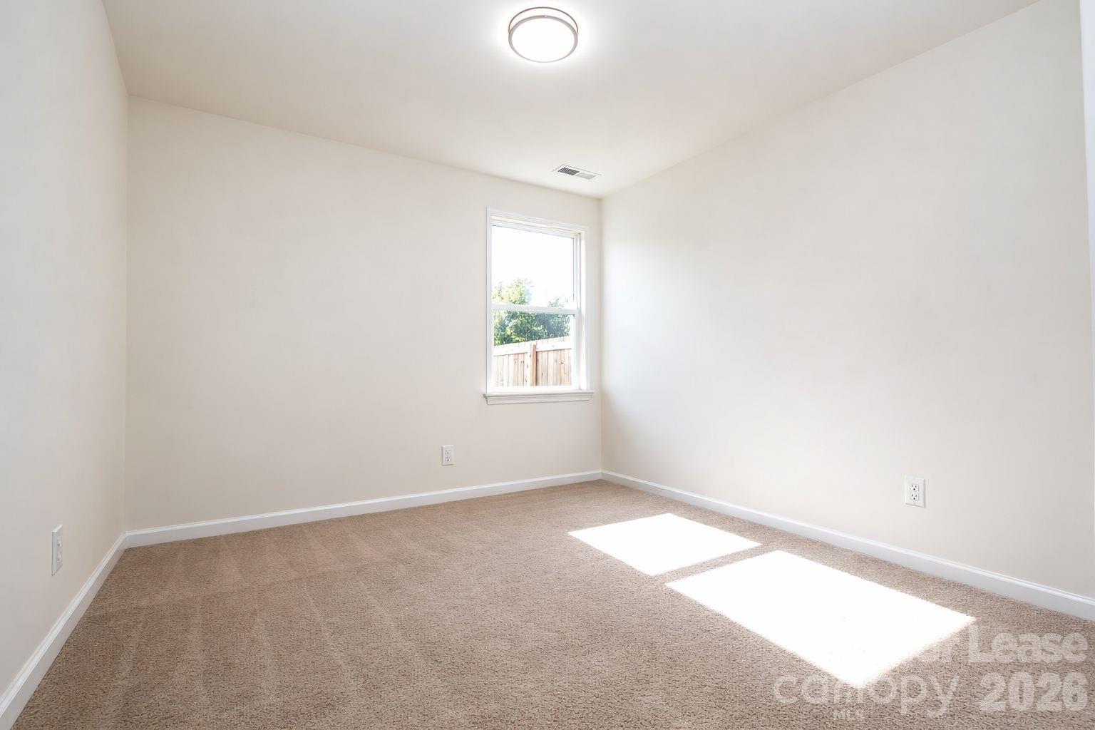 3220 Berry Creek Road Charlotte, NC 28214 - Photo 18 of 41 an empty room with a window