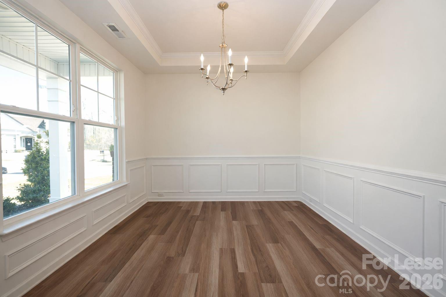 3220 Berry Creek Road Charlotte, NC 28214 - Photo 20 of 41 a view of a room with wooden floor and windows