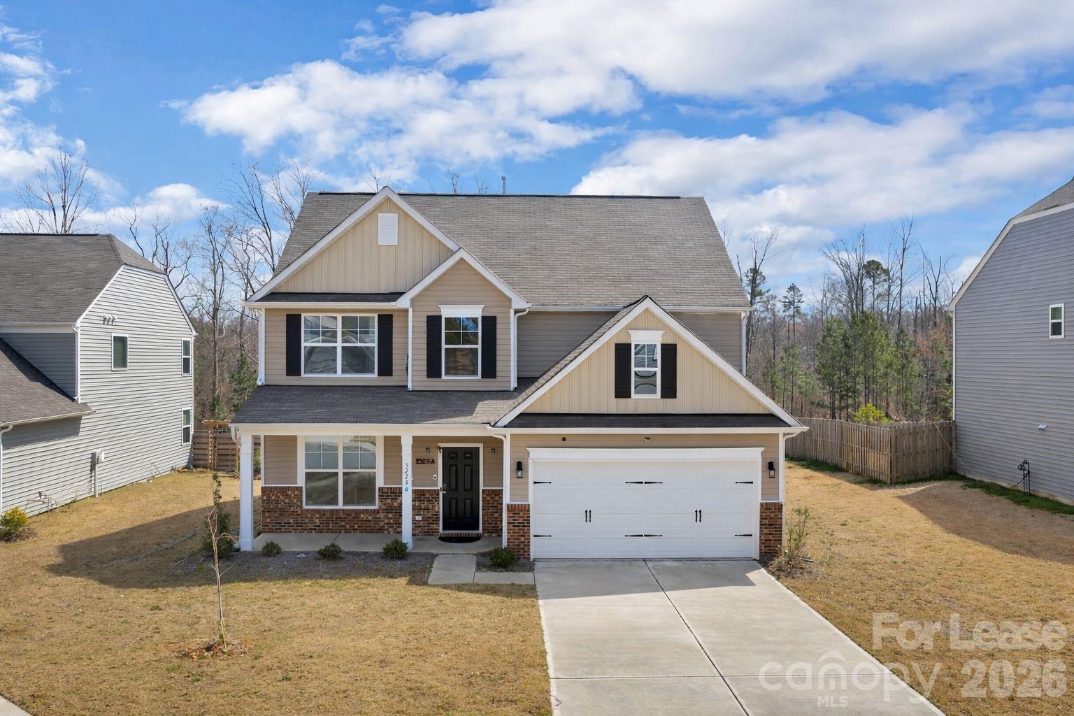 3220 Berry Creek Road Charlotte, NC 28214 - Photo 2 of 41 a front view of a house with a yard and garage