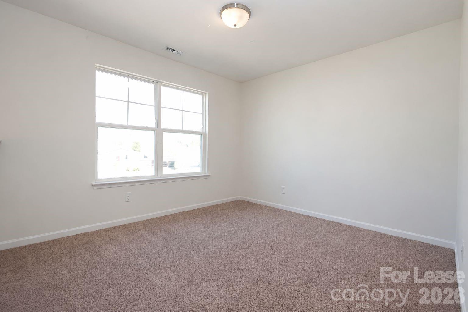 3220 Berry Creek Road Charlotte, NC 28214 - Photo 21 of 41 an empty room with a window