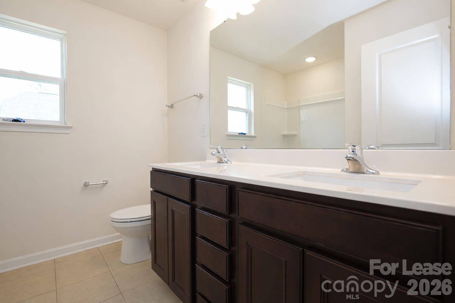 3220 Berry Creek Road Charlotte, NC 28214 - Photo 23 of 41 a bathroom with a sink and a toilet