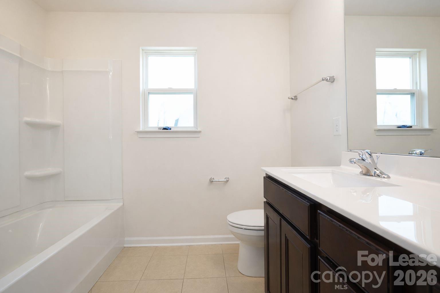 3220 Berry Creek Road Charlotte, NC 28214 - Photo 24 of 41 a bathroom with a sink toilet vanity and bathtub