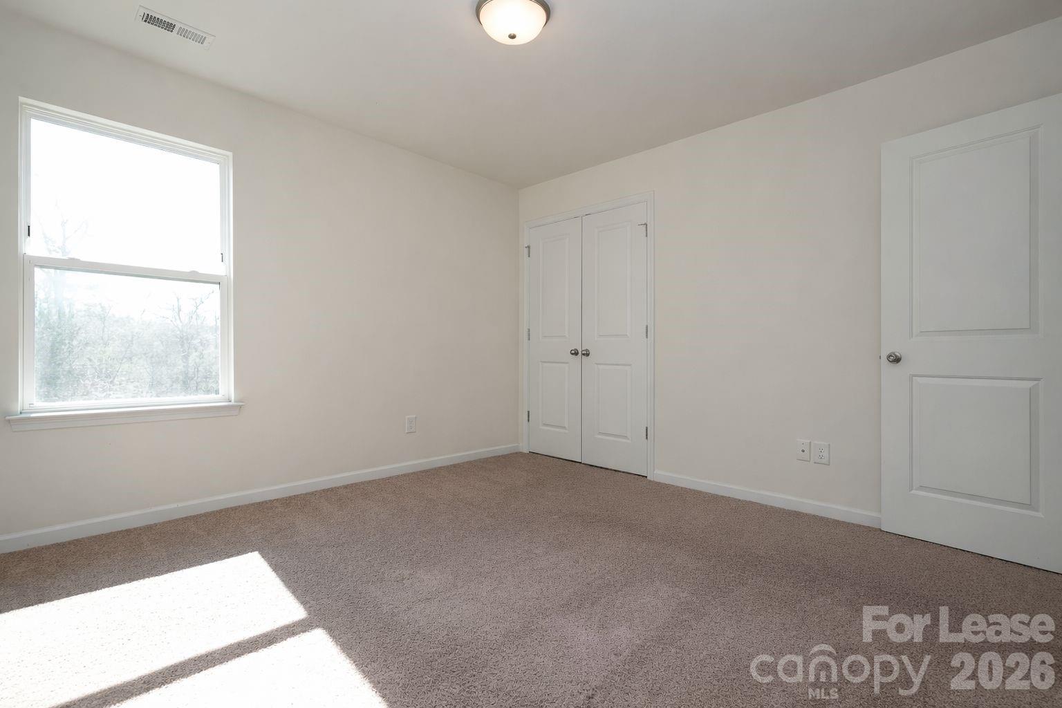 3220 Berry Creek Road Charlotte, NC 28214 - Photo 26 of 41 an empty room with windows