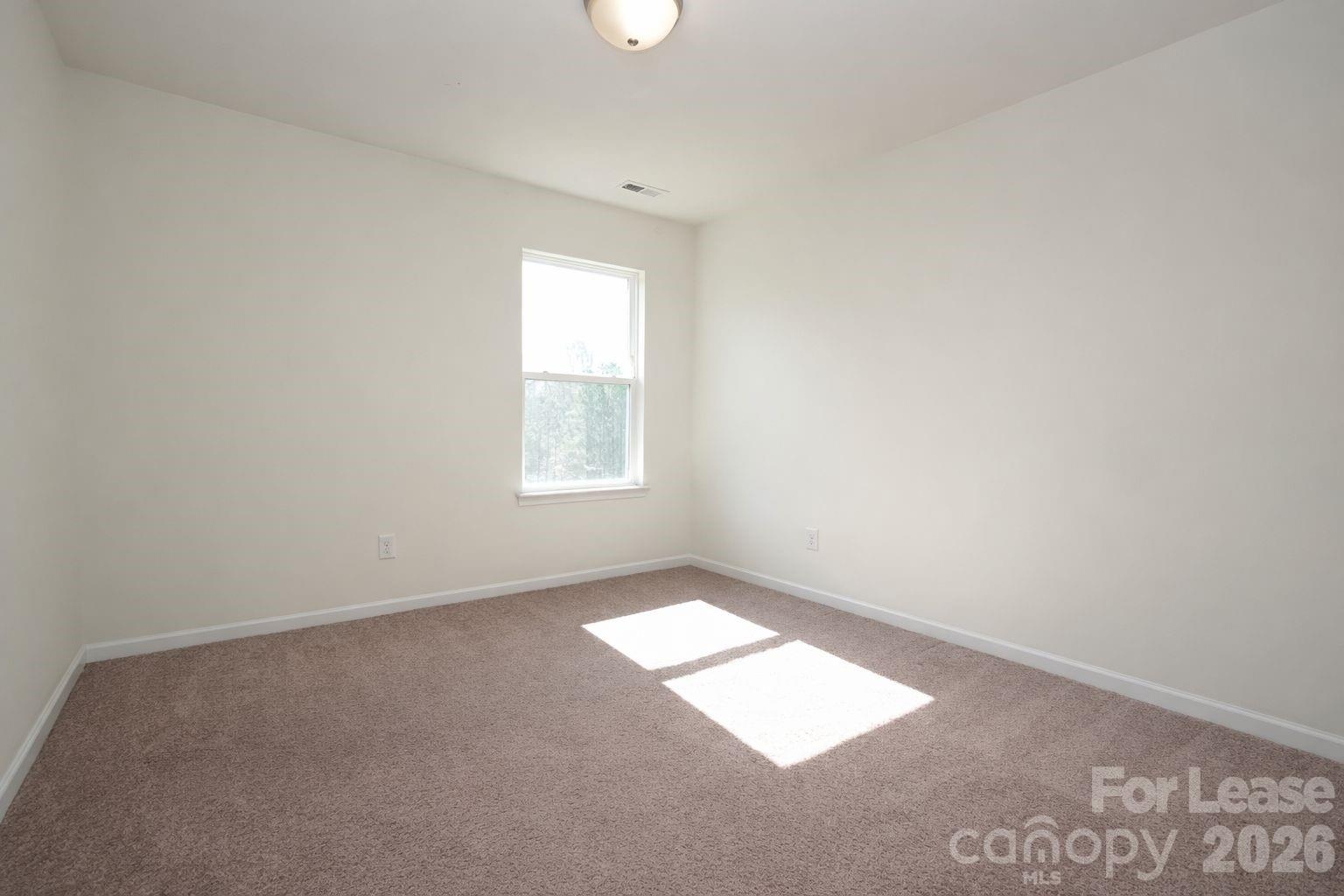 3220 Berry Creek Road Charlotte, NC 28214 - Photo 27 of 41 an empty room with windows