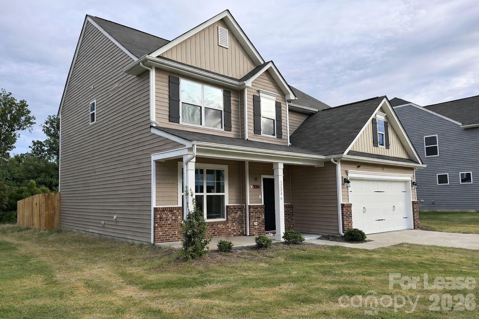 3220 Berry Creek Road Charlotte, NC 28214 - Photo 3 of 41 a front view of a house with a yard