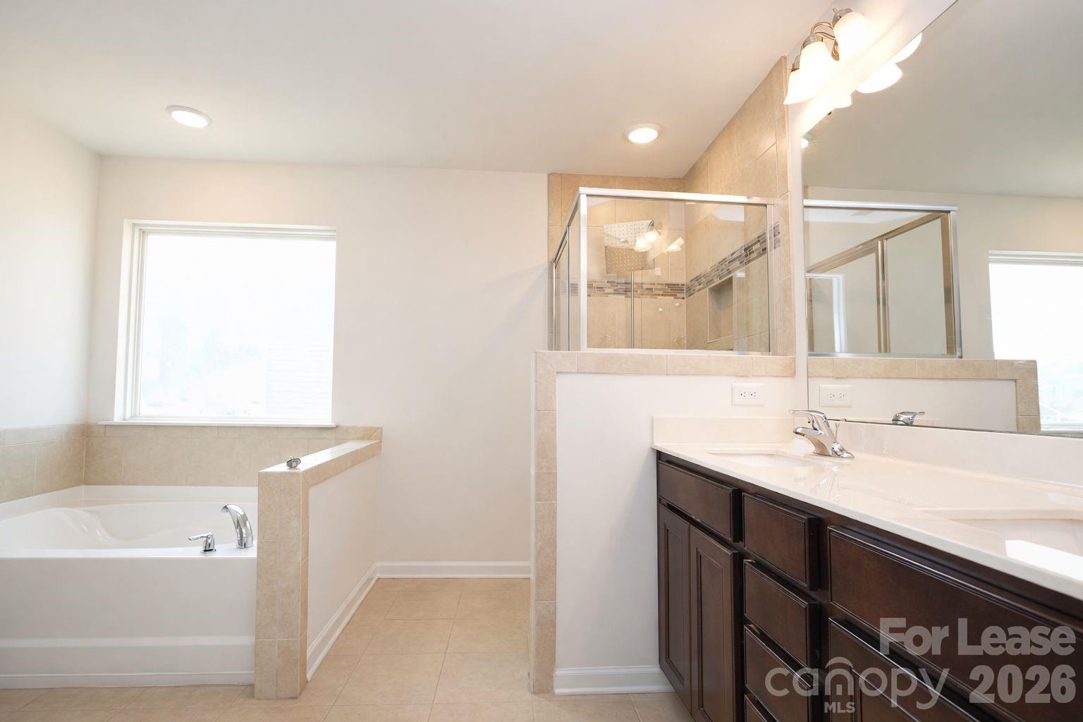 3220 Berry Creek Road Charlotte, NC 28214 - Photo 31 of 41 a bathroom with a tub sink and mirror