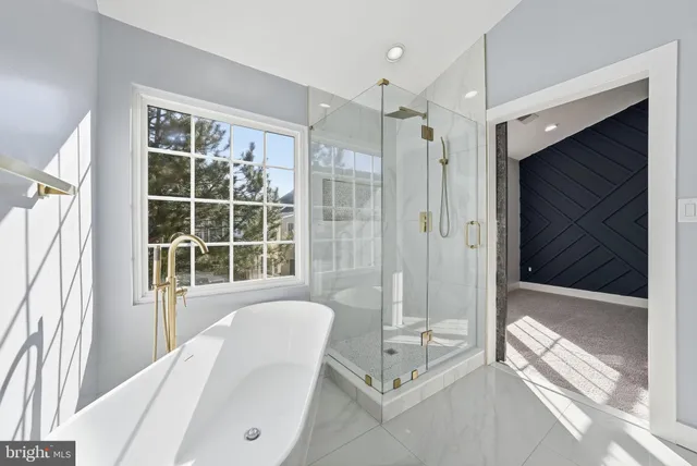 a spacious bedroom with a bed and a large window