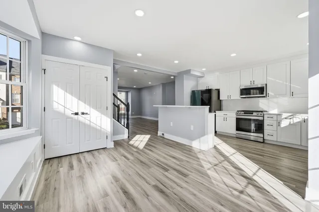 a view of a kitchen with microwave and cabinets