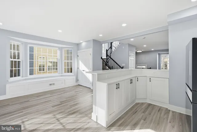 a view of a kitchen with wooden floor and a sink