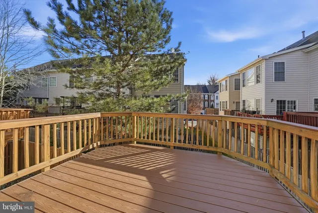 a view of balcony with wooden floor and fence