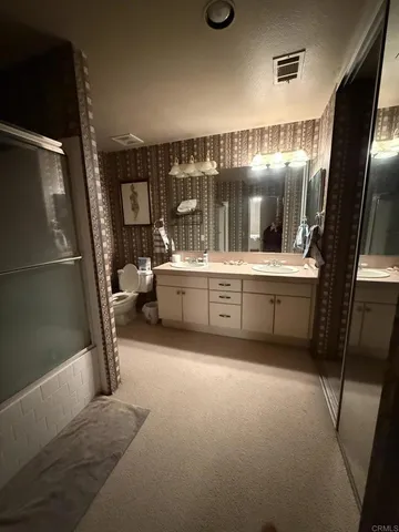 a bathroom with a sink a mirror and shower
