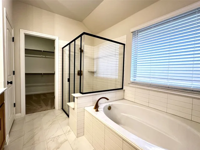 a bathroom with a bathtub and a sink