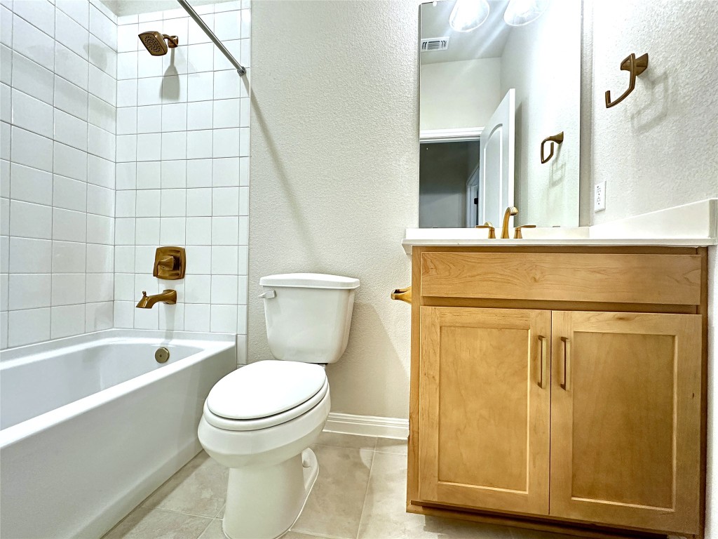 141 Rita Blanca Bend Bastrop, TX 78602 - Photo 18 of 23 a bathroom with a toilet a sink and bathtub
