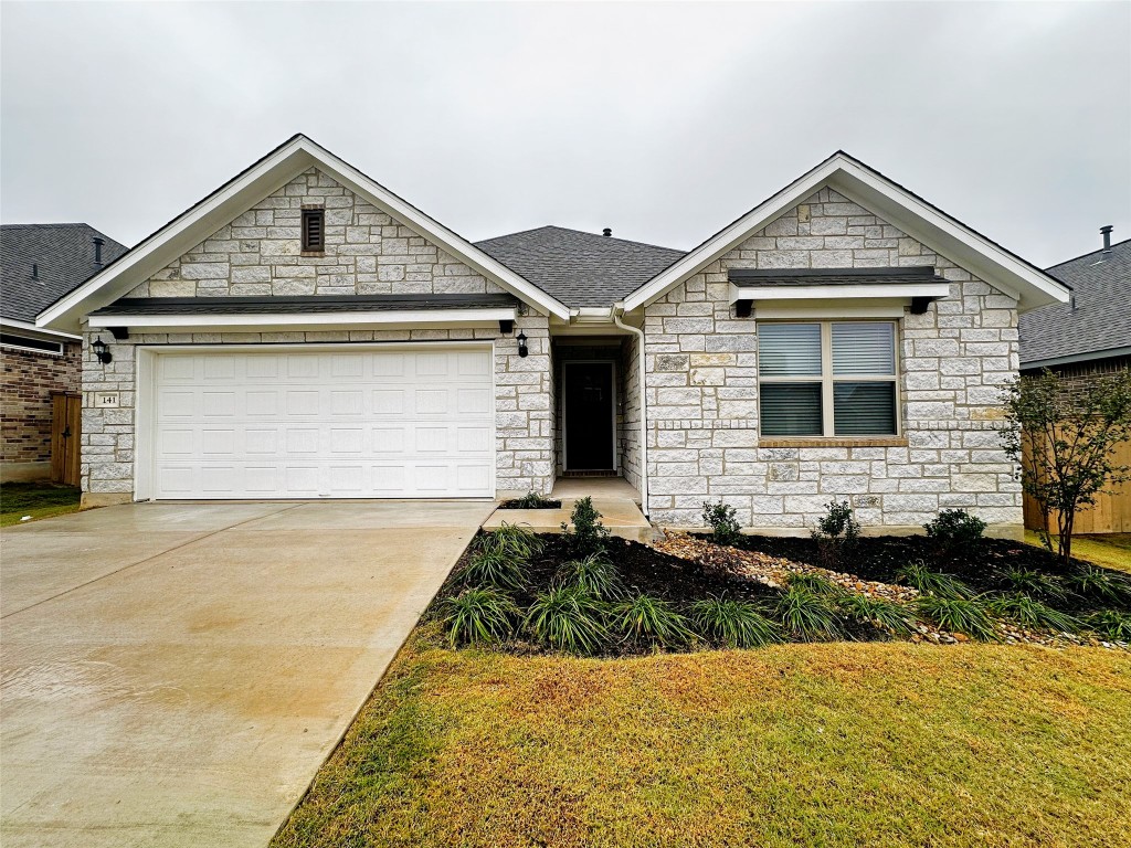 141 Rita Blanca Bend Bastrop, TX 78602 - Photo 21 of 23 a front view of a house with a yard