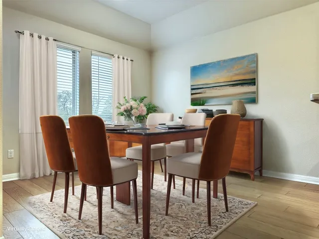a view of a dining room with furniture window and wooden floor