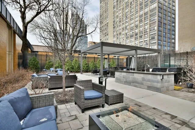 a view of a patio with couches and a fire pit