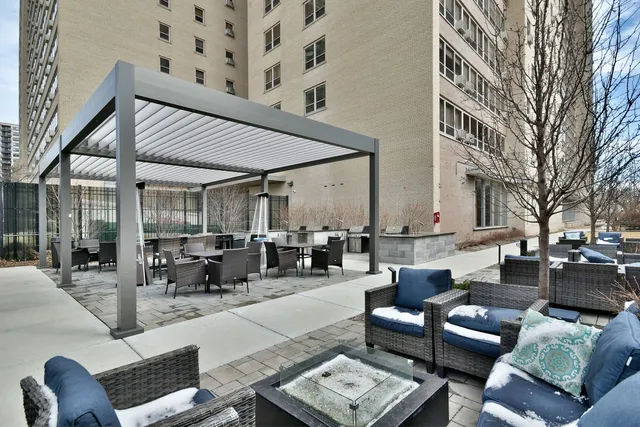 a view of a patio with couches and dining table with rug
