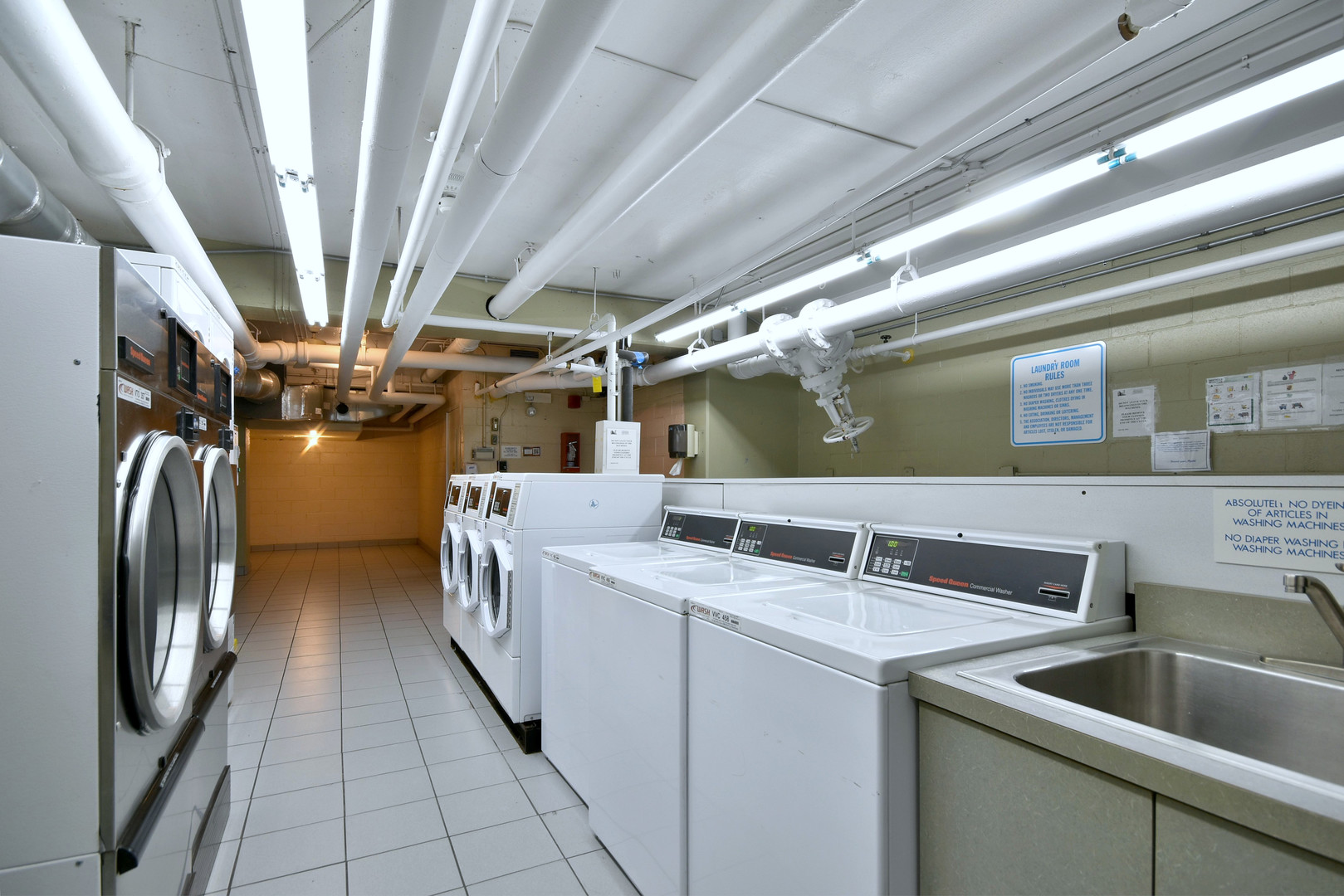 3950 North Lake Shore Drive, Unit 1202 Chicago, IL 60613 - Photo 30 of 32 a kitchen with a sink and refrigerator