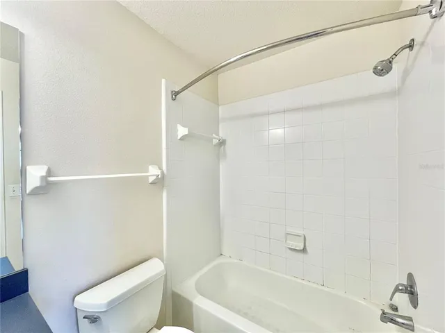 a bathroom with a bathtub and a toilet