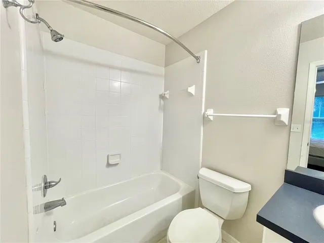 a bathroom with a toilet and a bathtub