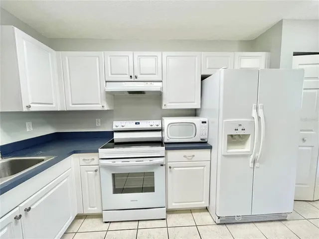 a kitchen with cabinets and stainless steel appliances