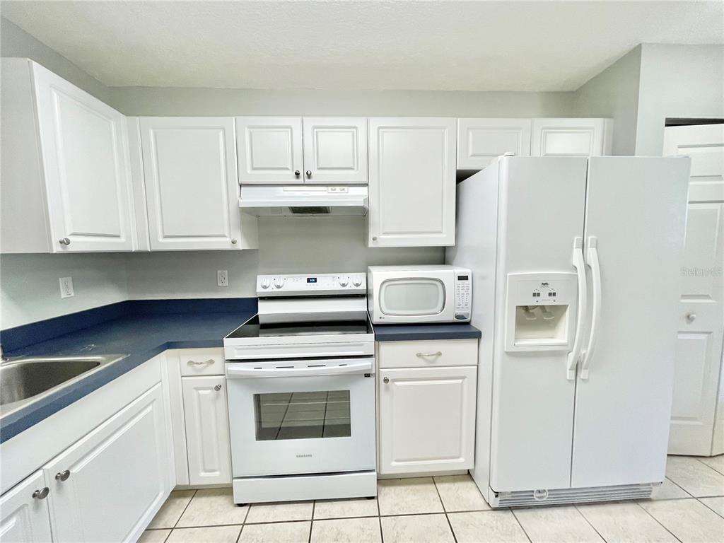 2348 Southwest 42nd Drive, Unit 151 Gainesville, FL 32607 - Photo 3 of 28 a kitchen with cabinets and stainless steel appliances