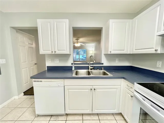 a kitchen with cabinets appliances a sink and a counter top space