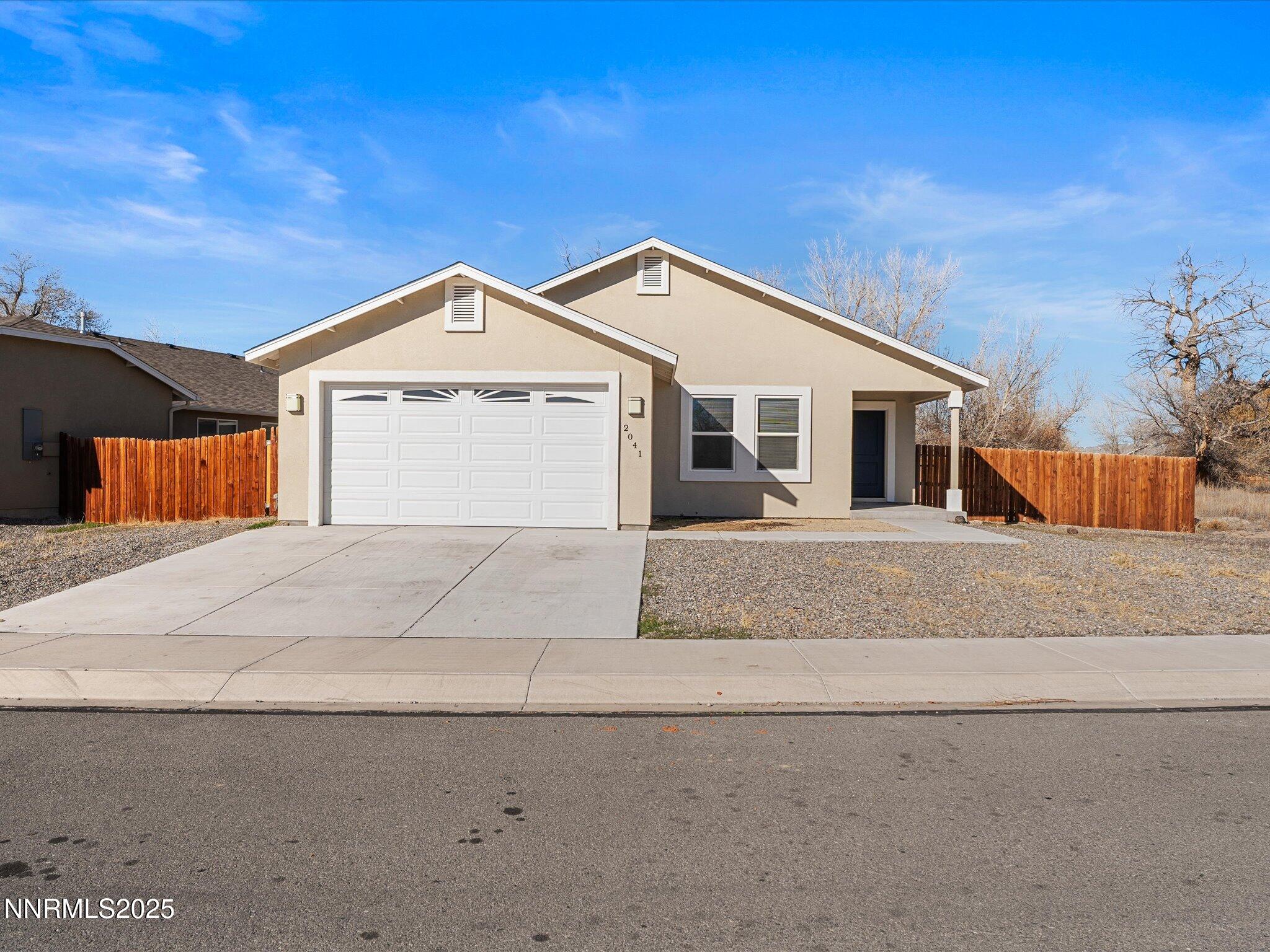 a front view of a house with a garage