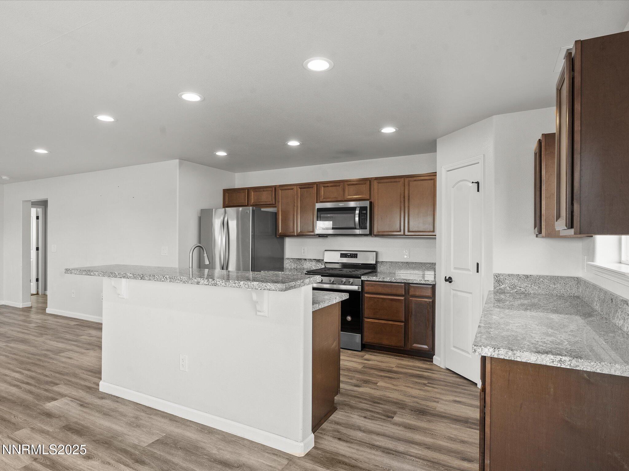 2041 Verona Drive Fallon, NV 89406 - Photo 12 of 45 a kitchen with stainless steel appliances granite countertop a stove top oven a sink and a refrigerator
