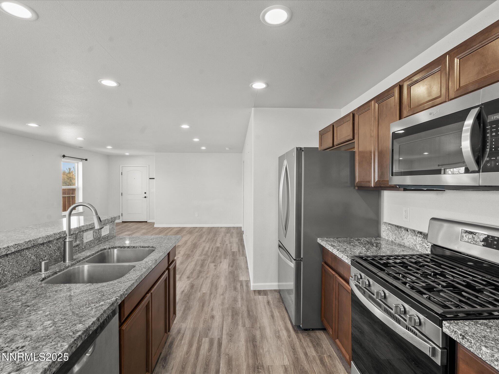 2041 Verona Drive Fallon, NV 89406 - Photo 14 of 45 a kitchen with stainless steel appliances granite countertop a sink stove and refrigerator